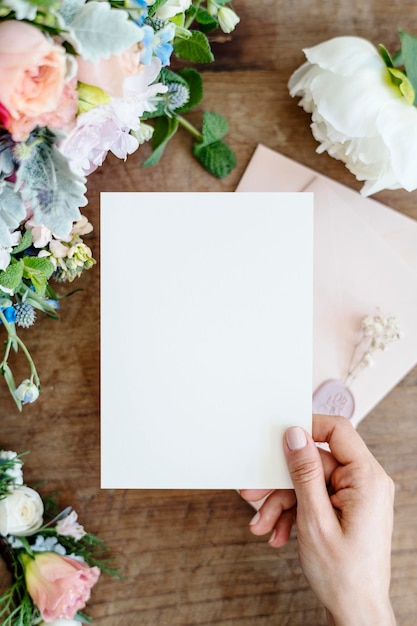 PSD woman holding a floral card mockup