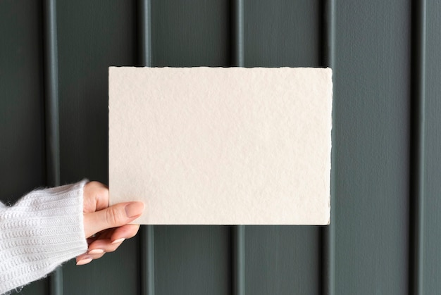 Woman holding a greeting card mockup