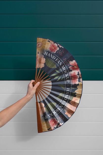 Woman holding hand fan with mock-up design