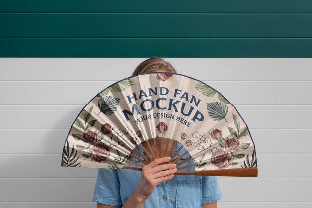 Woman holding hand fan with mock-up design