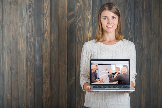 Woman holding laptop mockup