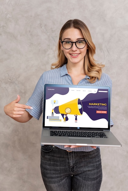 PSD woman holding a laptop and pointing at it