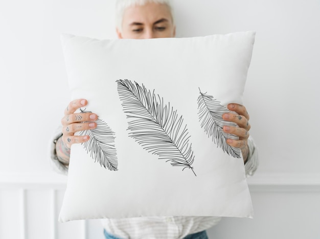 PSD woman  holding a leafy white pillow mockup