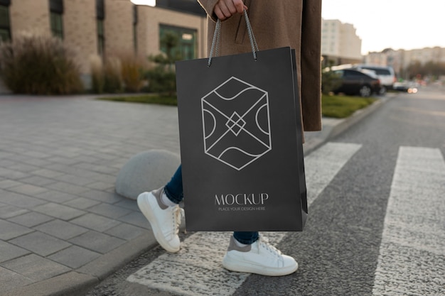 Woman holding luxurious shopping bag outdoors