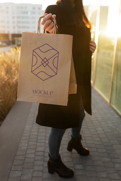 Woman holding luxurious shopping bag outdoors