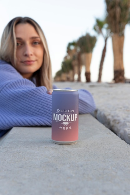 Woman holding a mock-up canned soda