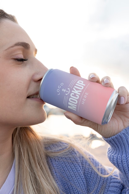 Woman holding a mock-up canned soda