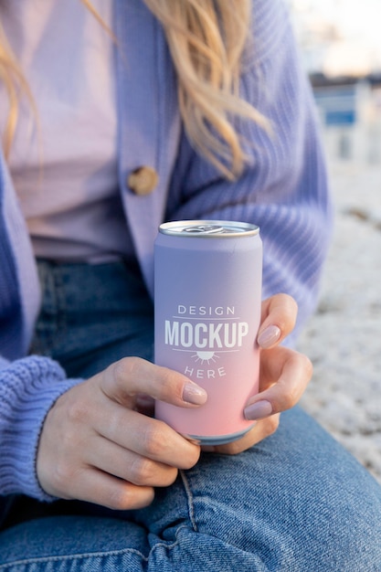 PSD woman holding a mock-up canned soda