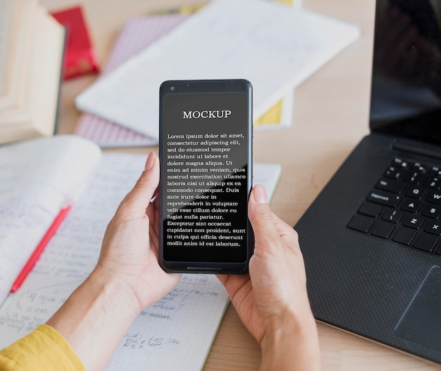 Woman holding a mock-up mobile phone