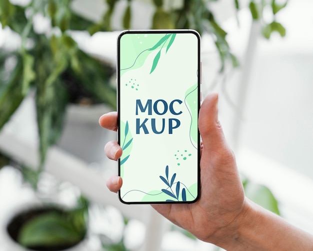 woman holding a mock-up smartphone in her urban orchard