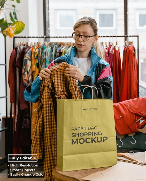 PSD woman holding paper bag shopping mockup