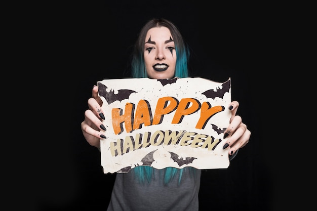 Woman holding paper with halloween lettering