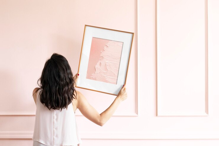 PSD woman holding picture frame mockup