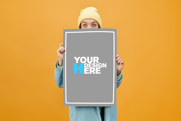 A woman holding a poster that says your design here.