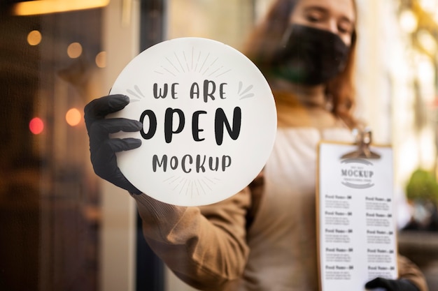 PSD woman holding a restaurant we are open sign