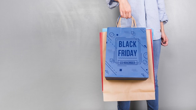 PSD woman holding shopping bag mockup with black friday concept