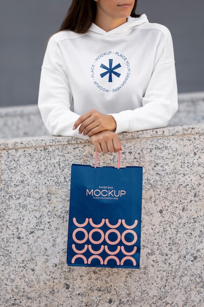 PSD woman holding shopping bag outdoors on the street