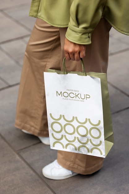 PSD woman holding shopping bag outdoors on the street