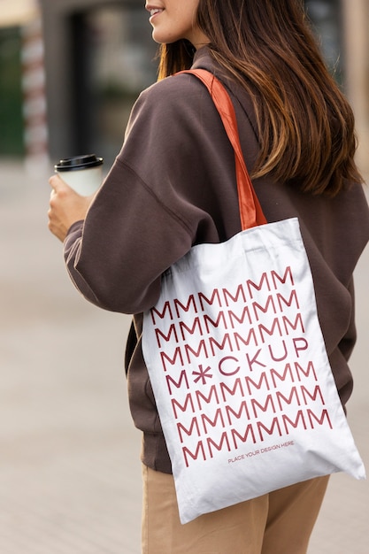 PSD woman holding shopping bag outdoors on the street