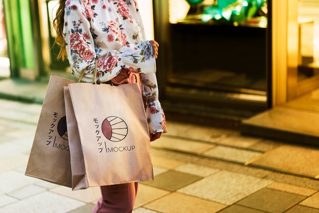 Woman holding shopping bags in the street