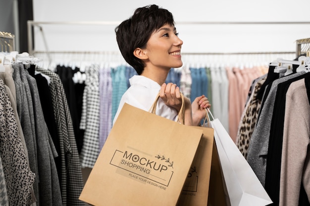 PSD woman holding a shopping paper bag mockup