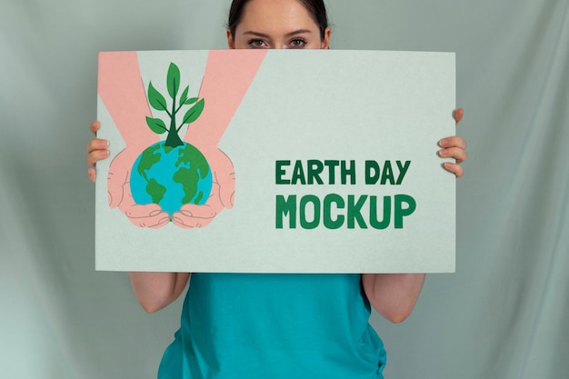 PSD woman holding signboard mock-up for earth day