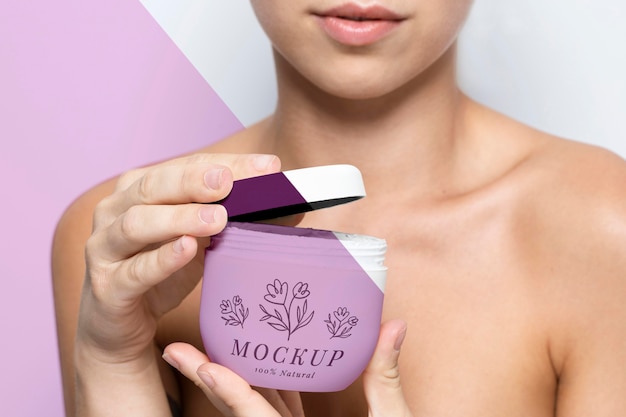 Woman holding a skincare product mock-up