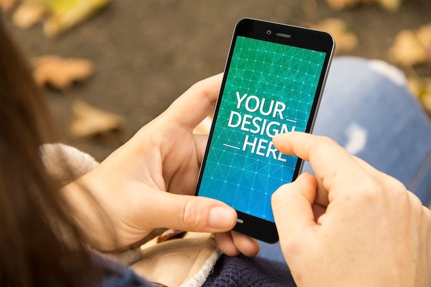 Woman holding smartphone mock up