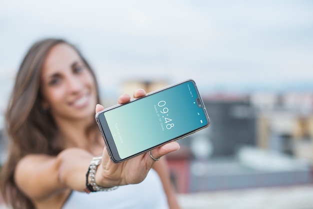 Woman holding smartphone mockup