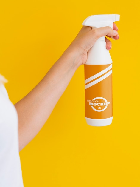 PSD woman holding a spraying bottle mock-up