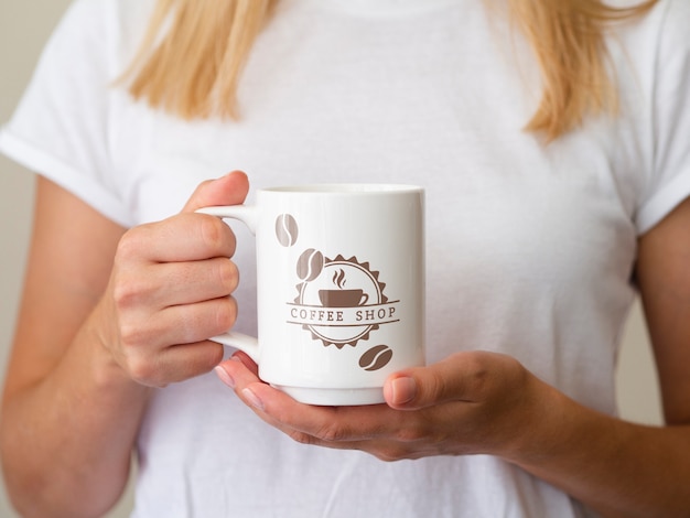 Woman holding up a coffee mug