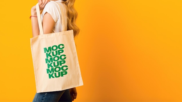 Woman is holding bag canvas fabric Mockup PSD Template 04