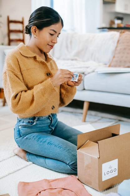 a woman is sitting on the floor and holding a tea cup