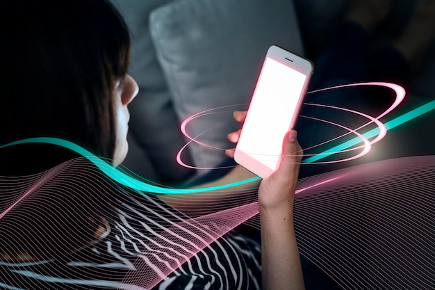 woman playing on her phone while laying on the couch
