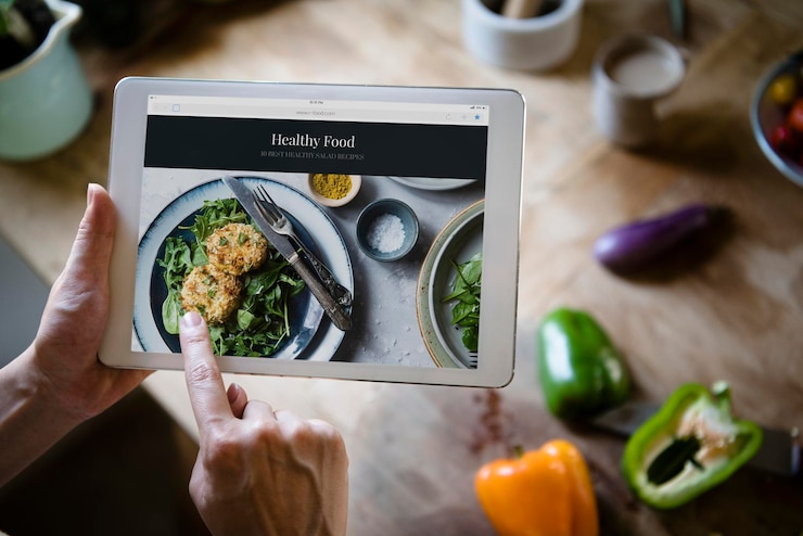PSD woman pointing at a screen with heathy foods