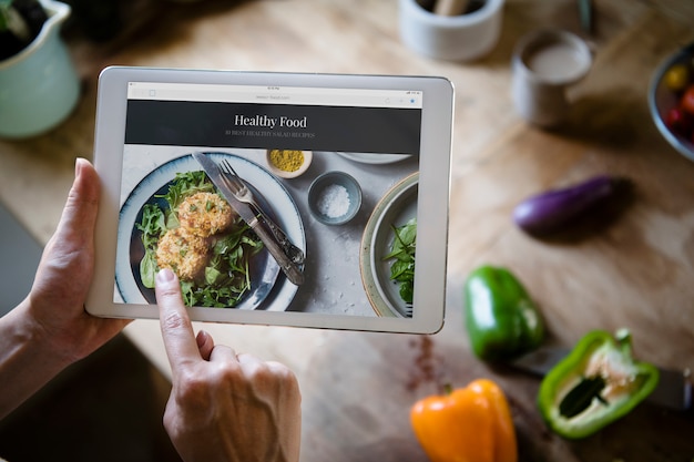 Woman pointing at a screen with heathy foods