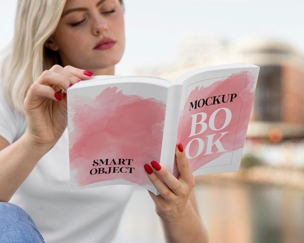 Woman reading book on street