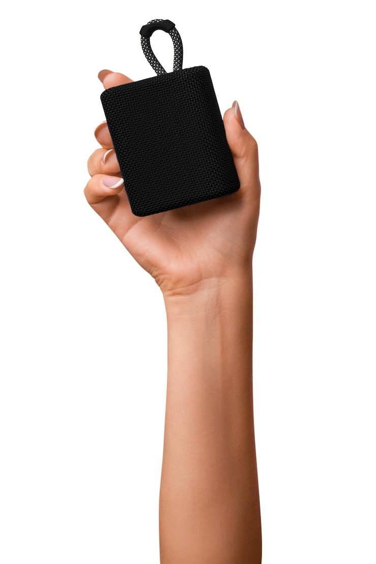 PSD a woman's hand holds a black bluetooth music speaker on isolated transparent background