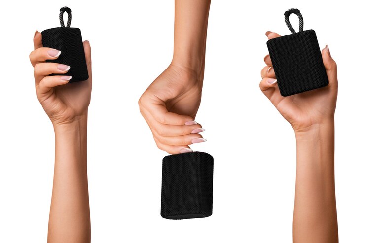 PSD a woman's hand holds a black bluetooth music speaker three options on isolated transparent background