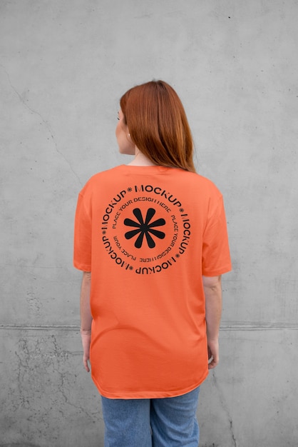 PSD woman showing back of t-shirt mock-up