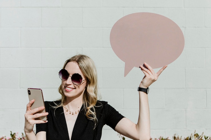 PSD woman showing a blank speech bubble while using her phone