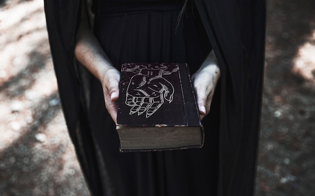 PSD woman showing a closed book with spells