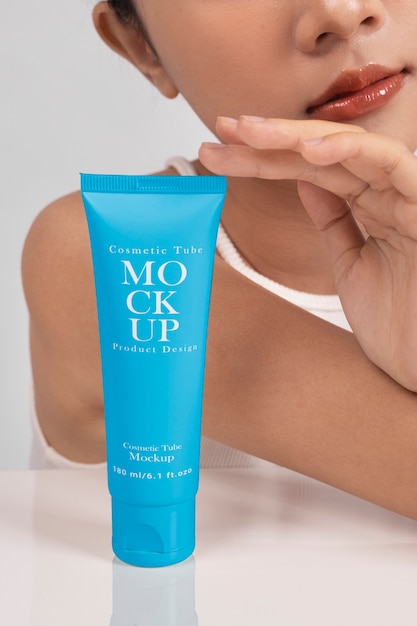 Woman showing face cream for skincare and beauty
