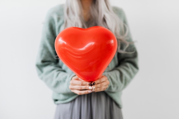 PSD woman showing a heart red balloon mockup