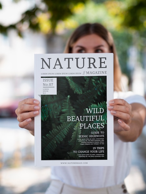 Donna che mostra una rivista di natura mock up