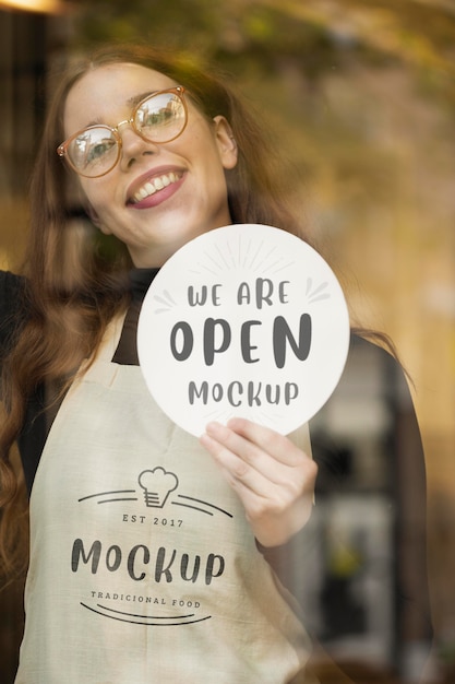 PSD woman showing a we are open mock-up sign