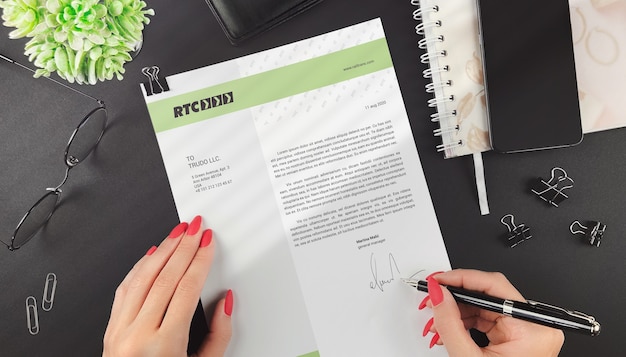 PSD woman signs a business letter mockup