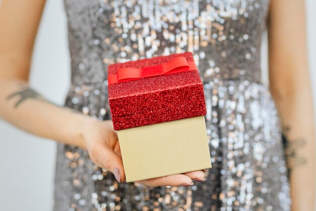 PSD woman in a silver dress holding gift boxes