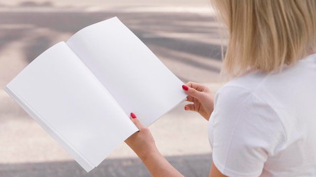 PSD woman on street reading book