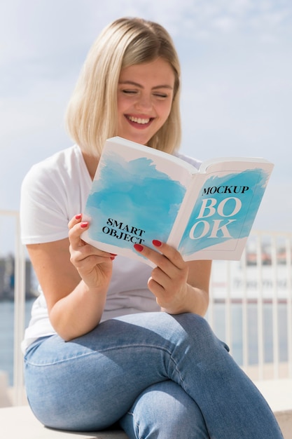 Woman on street reading book